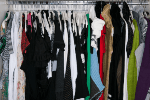 A messy and cluttered open closet