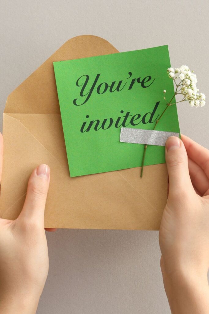 Birthday invitations are a must. In this image, there is a invite with a flower taped to the invitation