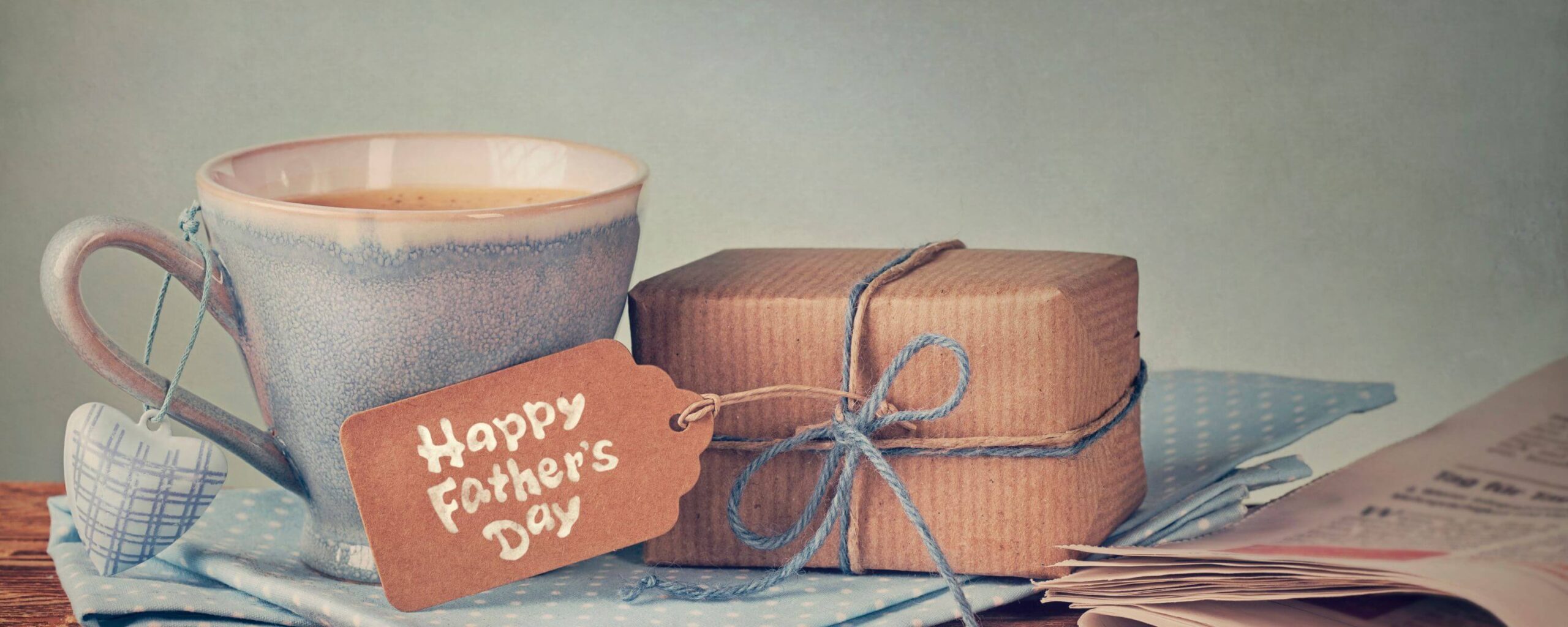 A mug and a wrapped gift with a tag that says “Happy Father’s Day"