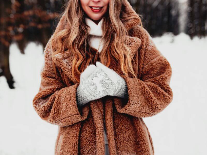 Winter Fashion - a woman wearing a winter coat and mittens