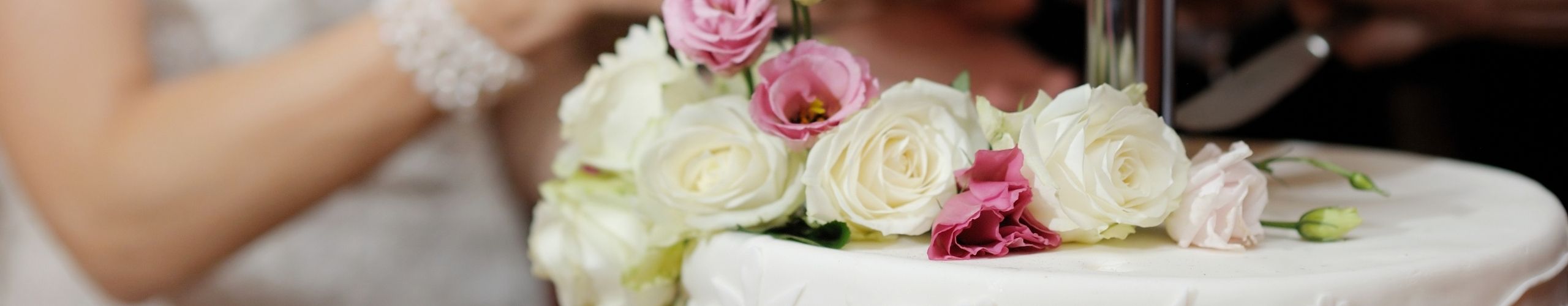 Bride cutting her Wedding Cake for a Celebration