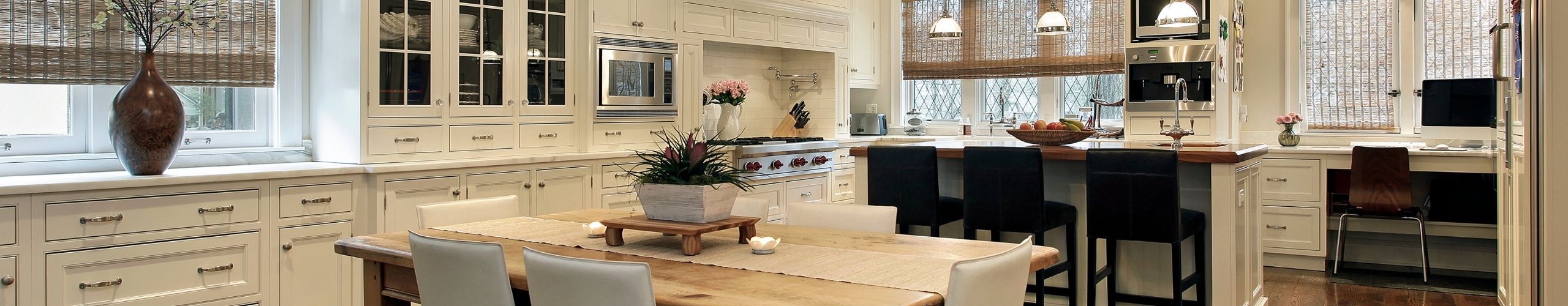a wide amgle of a white kitchen