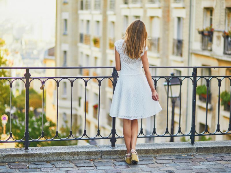 Perfection is the Enemy of Progress: A woman standing on a balcony looking out